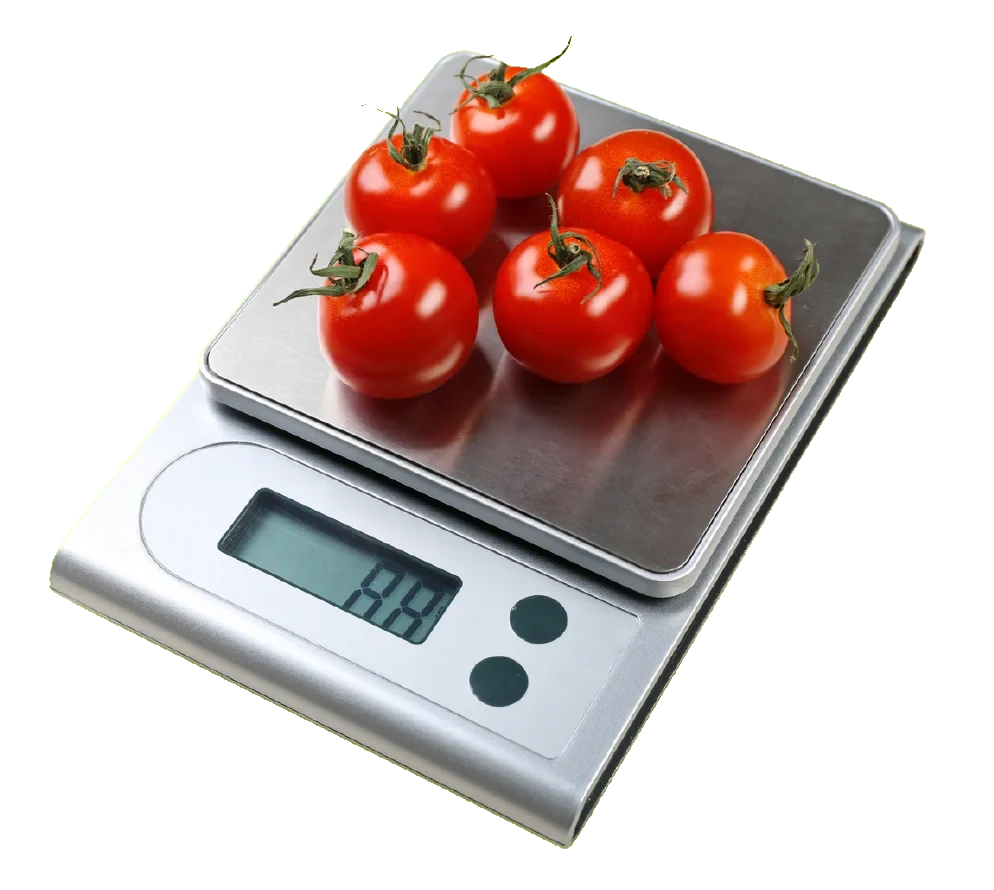Digital kitchen scale weighing tomatoes